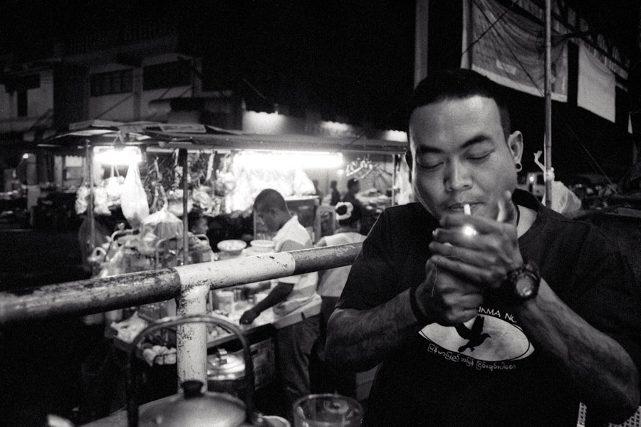 2010: Late-night Burmese tea shop next to the market, open for vendors receiving deliveries. In 2010, a t-shirt like this, reading 'Peace in Burma Now' would not have been welcomed on the other side of the border.