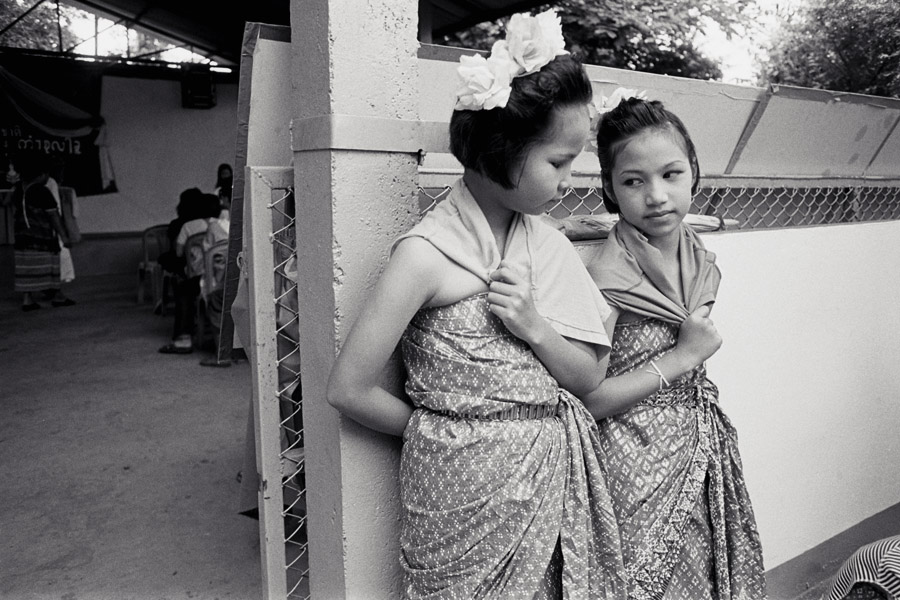 2011: At the traditional Karen ethnic group's 'wrist-tying festival', held yearly usually in August. Mae Sot has a huge celebration encompassing ethnic Karen who are nationals of either country, and welcomes the whole community, but in 2011 I attended a small Thai-only celebration in Padaeng village nearby. <br><br>These girls were waiting to dance, after community announcements, and health information.