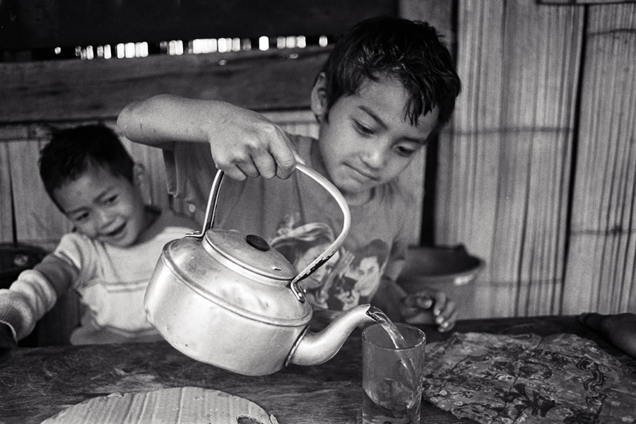 Ban Wy village, Eastern Shan State 2012: extremely giggly Lahu boys from a tea-growing family pour a welcome drink.