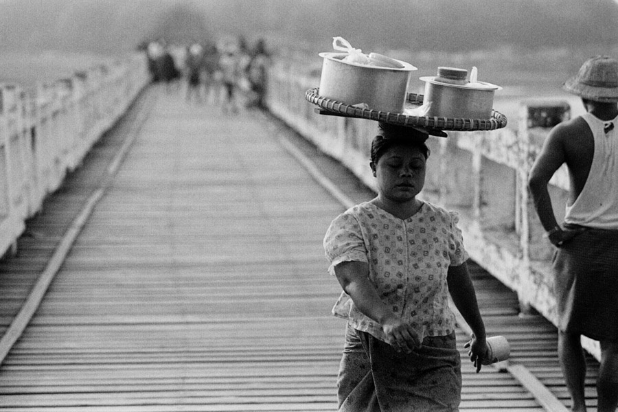 Amarapura 2012: food vendor walks across the famed U Bein bridge, the oldest and longest teak bridge in the world.