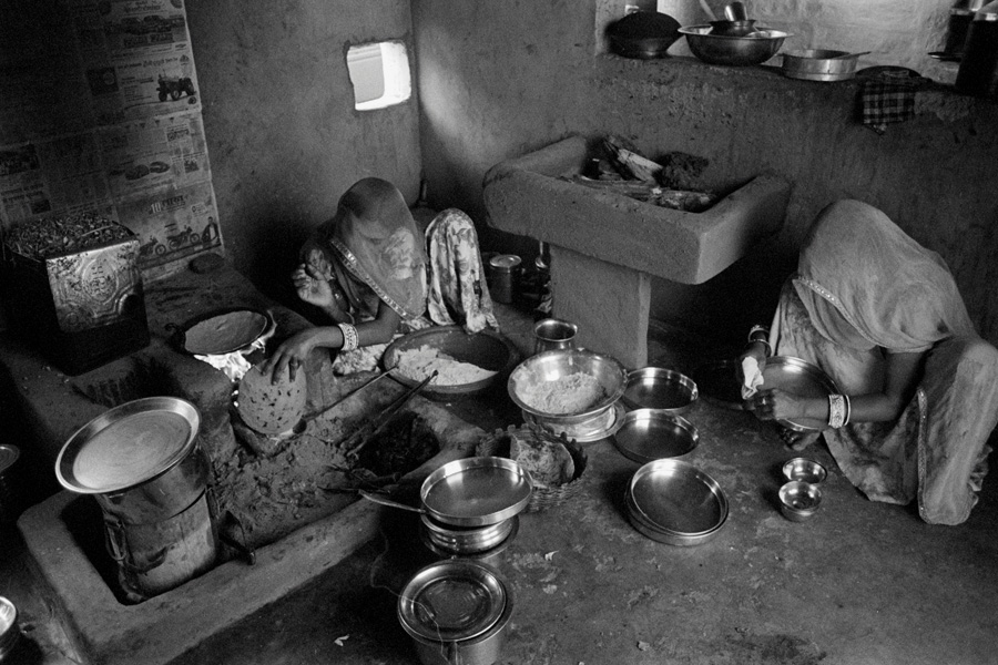 Bishnoi village, India 2014: Young wives clean dishes and make chapatis before lunch. Due to the desert location, minimal water is used for preparations.
<br><br>
Bishnois are a religious  minority with villages about 40 minutes out of Jodhpur. They lead a pastoral lifestyle, produce beautiful handicrafts, and are so spiritually connected to the environment that in 1731 hundreds of Bishnois were killed literally hugging trees to prevent them from being logged for the maharajah's palace.