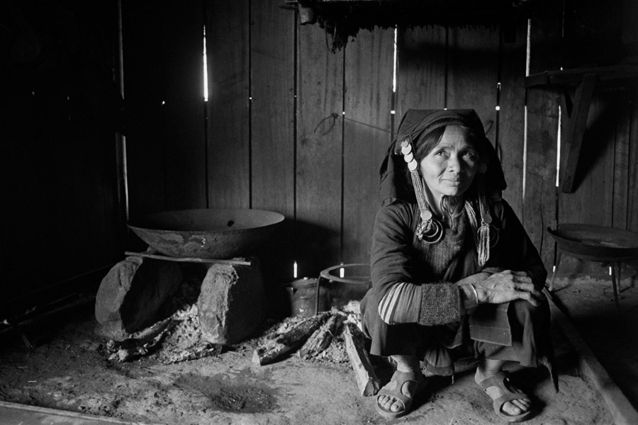 Buon Pays, Laos 2011: Akha village reached by bus and long trek from Phongsali. Relaxing with the village chief's wife in the only warm part of the house.