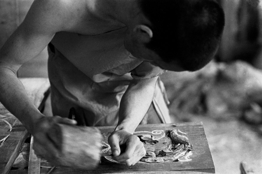 Luang Prabang, Laos 2011: at Wat Xieng Moune, monks from all over Laos participate in a UNESCO program to re-teach the skills of designing and maintaining temples. The program began about 10-11 years ago, and runs 3 years at a time. More monks were involved when they were studying painting and drawing, then some dropped out when they started Buddha sculpture, and by the time they were doing wood-carving only 4 young monks remained.

<br><br>Novice Phet, pictured, wishes to only remain a monk for a few more years, then travel around the country improving temples as a master craftsman, just like his teacher.